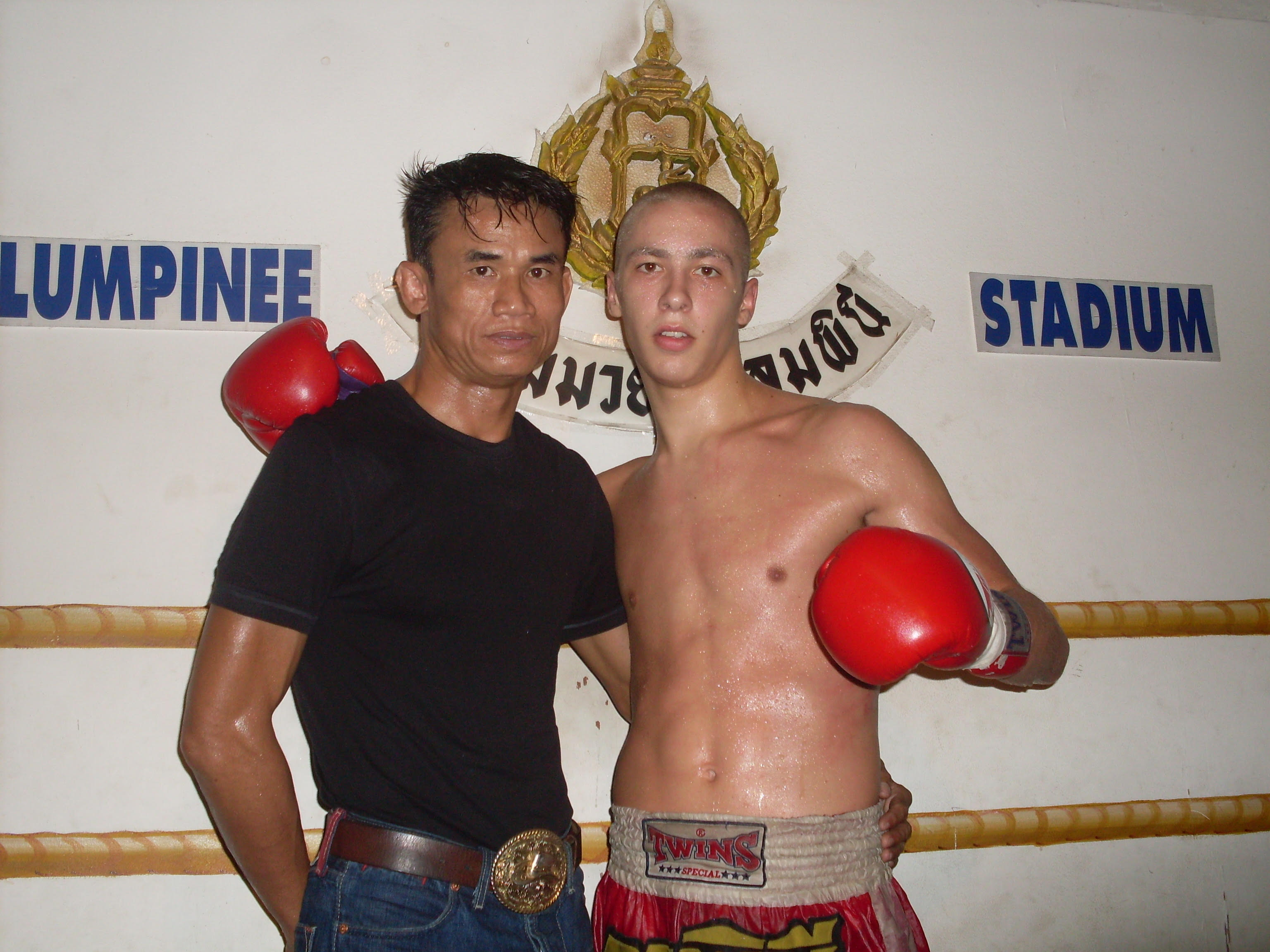 Brian Denis alongside Pipa, the head coach of Jocky Gym, after a victory at Lumpinee Stadium.